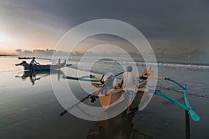 Fishermen prepare to sea at yeh gangga beach, tabanan, bali, indonesia