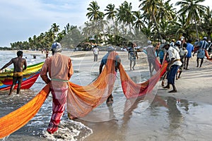 Fishermen pull in their fishing nets onto the beach at Uppuveli in Sri Lanka.