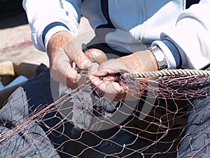Fishermen repairing fishing nets