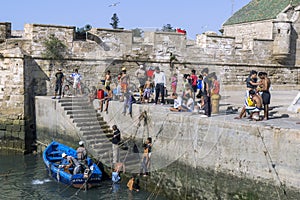 Fishermen return with their catch to the busy fishing harbour at Essaouira in Morocco