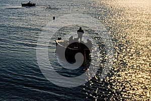 Fishermen set stationary nets at sunset