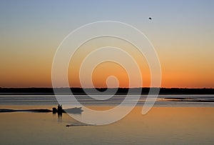 Fishermen Silhouette At Orange Sunset With Birds