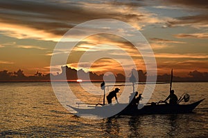 Fishermen silhouette at sunset. White Beach, station one. Boracay Island. Aklan. Western Visayas. Philippines