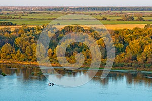 Fishermen sit in the boat on the river