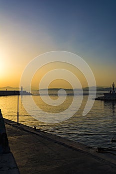 Fishermen at sunset in Alimos marina in Athens, Greece