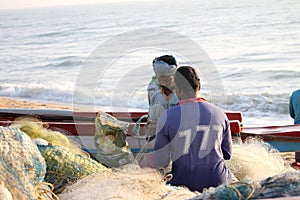 Fishermen Taking out fish from their gill net in Tamil Nadu, India