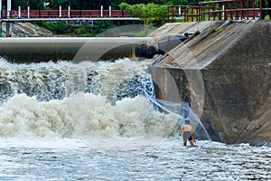 Fishermen, throw a net,Fishermen throw a net on the rubber dam .