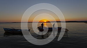 Fishermen throwing fishing net into the sea