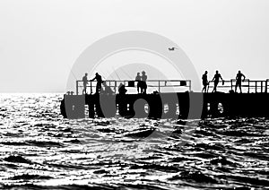 Fishermen and vacationers on a pier