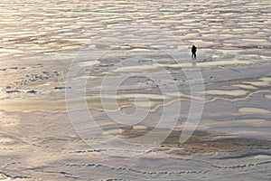 Fishermen walking on the frozen sea