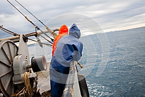 Fishermen in waterproof suits on the deck of the fishing vessel