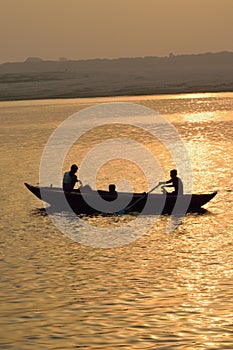 Fishermen on wooden boats at Ganges river in Varanasi, India