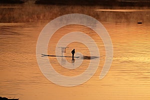 Fishermen working at sunrise photo