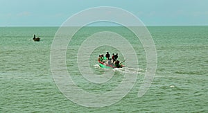 Fishermen at works on the wooden motor boat.