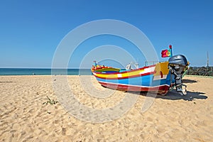 Fishers boat on the beach in Armacao de Pera in the Algarve Portugal photo