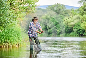 Fishers have long rods. retired bearded fisher. Trout bait. fisherman with fishing rod. mature man fly fishing. man