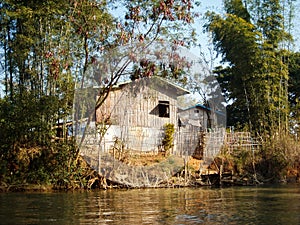 a fishers house at the river in burma