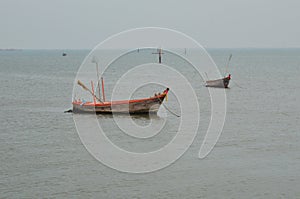 Fishery boat floating on the dull sea