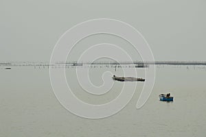 Fishery boat floating on the dull sea