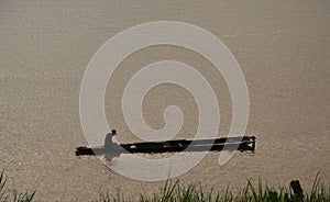 Fishery row boat in the river on sunset