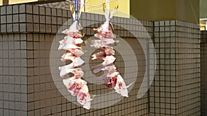 Fishes being air dried on a balcony horizontal compositon