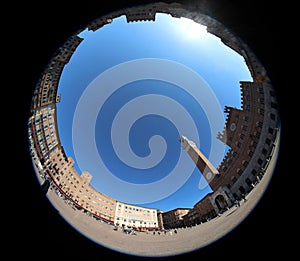 fisheye lens view of the Tower called TORRE DEL MANGIA in the main Piazza of SIENA in Italy photo