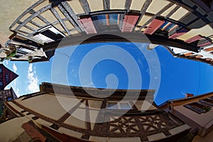 Fisheye view of the sky above a narrow street in Riquewihr town, France