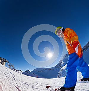 Fisheye view of smiling boy in ski mask skiing