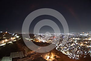 Fisheye wide shot of cityscape lights stretching off into the distance view from mehrangarh fort of Jodhpur city