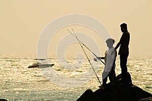 Fishermen on rocks photo