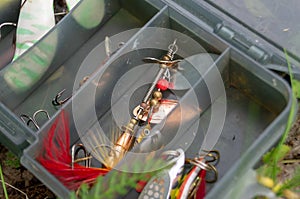 Fishing accessories in a plastic box. set of Spinners and lures
