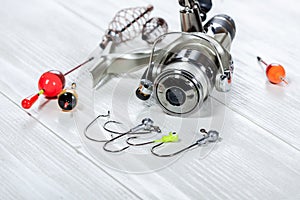 Fishing accessories on a wooden background.