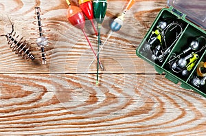 Fishing accessories on a wooden background.