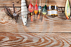Fishing accessories on a wooden background.
