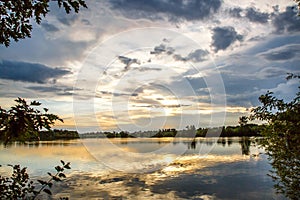 Fishing adventures, carp fishing. Angler, at sunset, is fishing with carpfishing technique. Camping on the shore of the lake.Carp photo