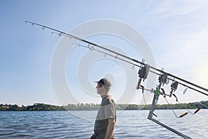 Fishing adventures, carp fishing. Man fishing on the lake