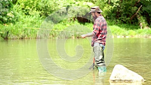 Fishing. American angler fishing. Still water trout fishing. Fly fishing. Handsome fisherman in a river.