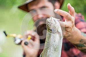 Fishing. Angler with fishing trophy. Fisherman and trout. Fishing backgrounds. Man hold big fish trout in his hands