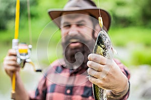 Fishing. Angler with fishing trophy. Fisherman and trout. Fishing backgrounds. Man hold big fish trout in his hands