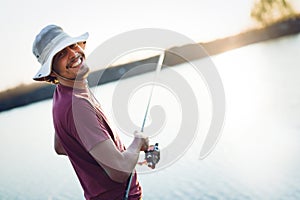 Fishing as recreation and sports displayed by fisherman at lake