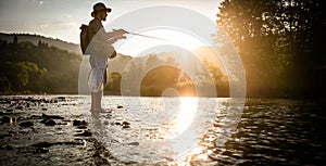 Fishing background. Fisherman catching on a river.