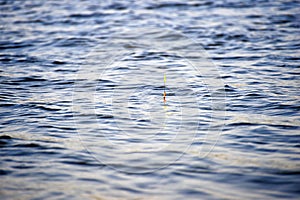 Fishing background: float bobs on the waves.