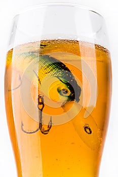 Fishing bait wobbler in glass with beer
