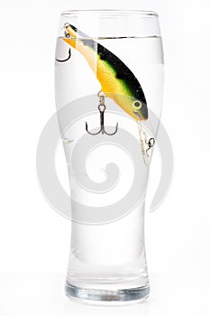 Fishing bait wobbler in glass with water