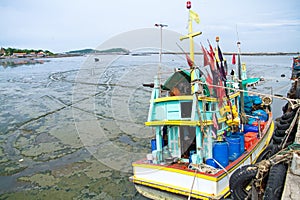 Fishing boat aground at the fishing pier at low tide