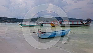 Fishing boat on the beach and in the bay of Koh Rong Samloem, tropical ocean, paradise