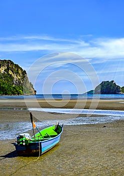 fishing boat on the beach with blue sky background in Thailand