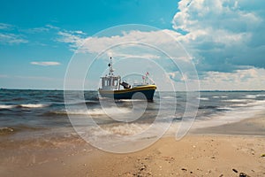 Fishing boat on the beach in Sopot, Poland. Magnificent long exposure calm Baltic Sea. Wallpaper defocused waves