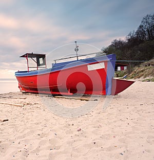 Fishing boat on the beach. Tranquil evening landscape.