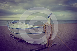 Fishing boat on the beach with vintage effect